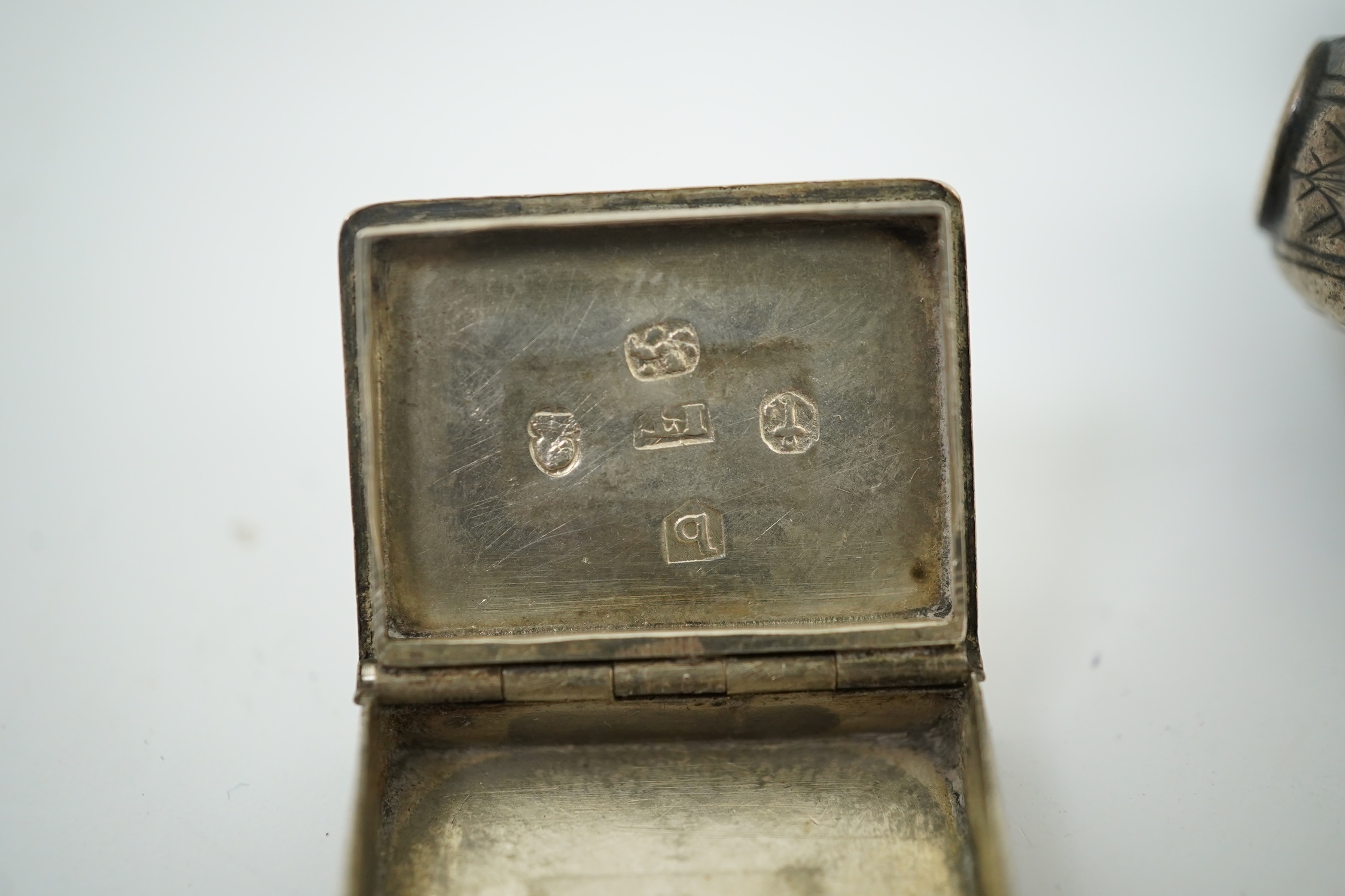 A 17th century style miniature silver snuff box, 40mm, a miniature 'book' box and a token/counter box with one counter. Condition - poor to fair